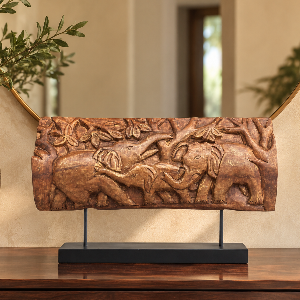 Hand-carved wooden elephant family decorative panel on a black metal stand styled on a wooden console.