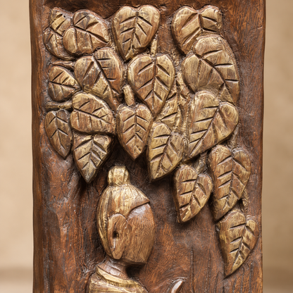Close-up of hand-carved wooden decorative sculpture with antique gold-toned leaf detailing and carved figure.
