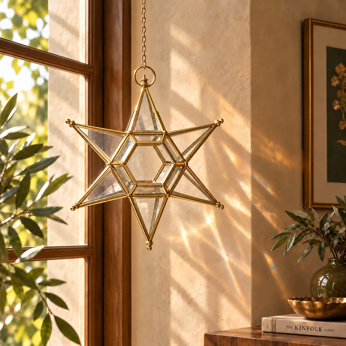 Handcrafted brass hanging star lantern displayed beside a sunlit window, adding elegant indoor décor with beautiful natural light reflections.