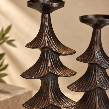 Close-up of handcrafted rustic metal Christmas tree candle holder highlighting textured finish and premium craftsmanship.