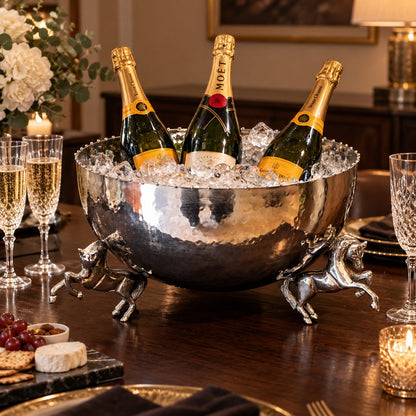 Luxury hammered metal horse leg bowl used as an elegant champagne and wine cooler filled with ice for entertaining and celebrations.