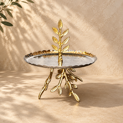Inara luxury gold leaf branch platter with hammered stainless steel finish against a warm textured backdrop.