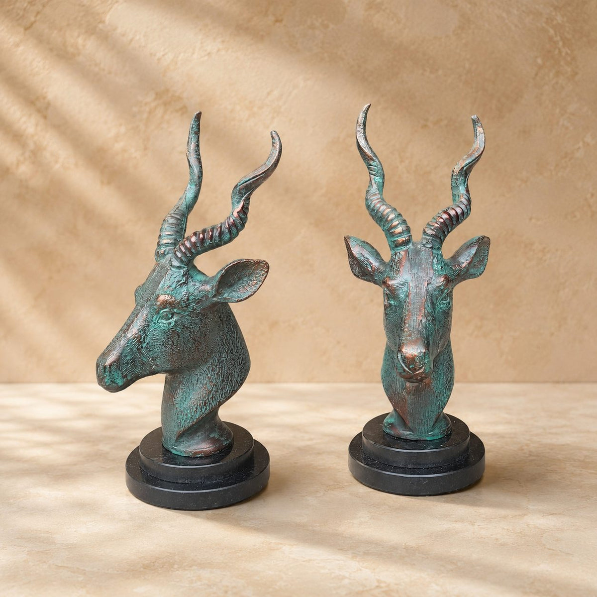 Luxury handcrafted antique bronze deer head sculpture displayed from front and side angles, highlighting intricate detailing and artistic finish.