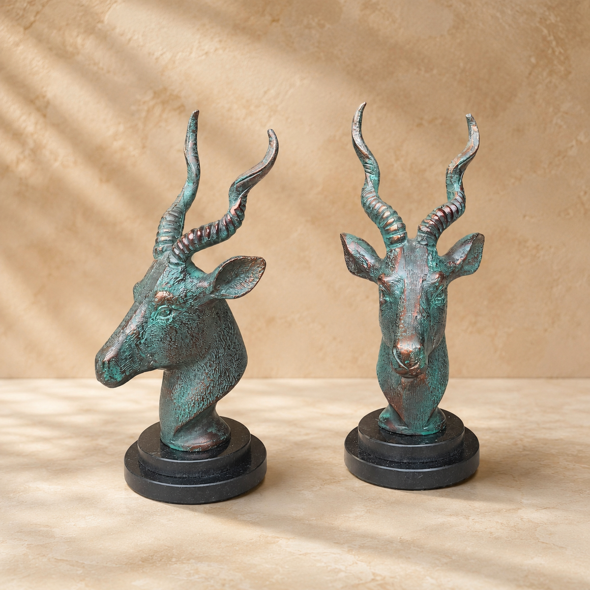 Luxury handcrafted antique bronze deer head sculpture displayed from front and side angles, highlighting intricate detailing and artistic finish.
