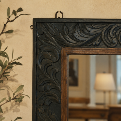 Close-up lifestyle image of a hand-carved wooden mirror frame showcasing intricate floral detailing in a luxury home interior.
