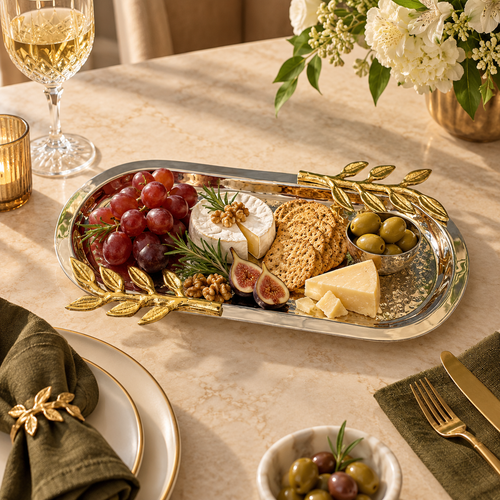 Luxury Leaf Handle Hammered Serving Tray styled with cheese, grapes, olives, crackers, and figs on an elegant dining table.