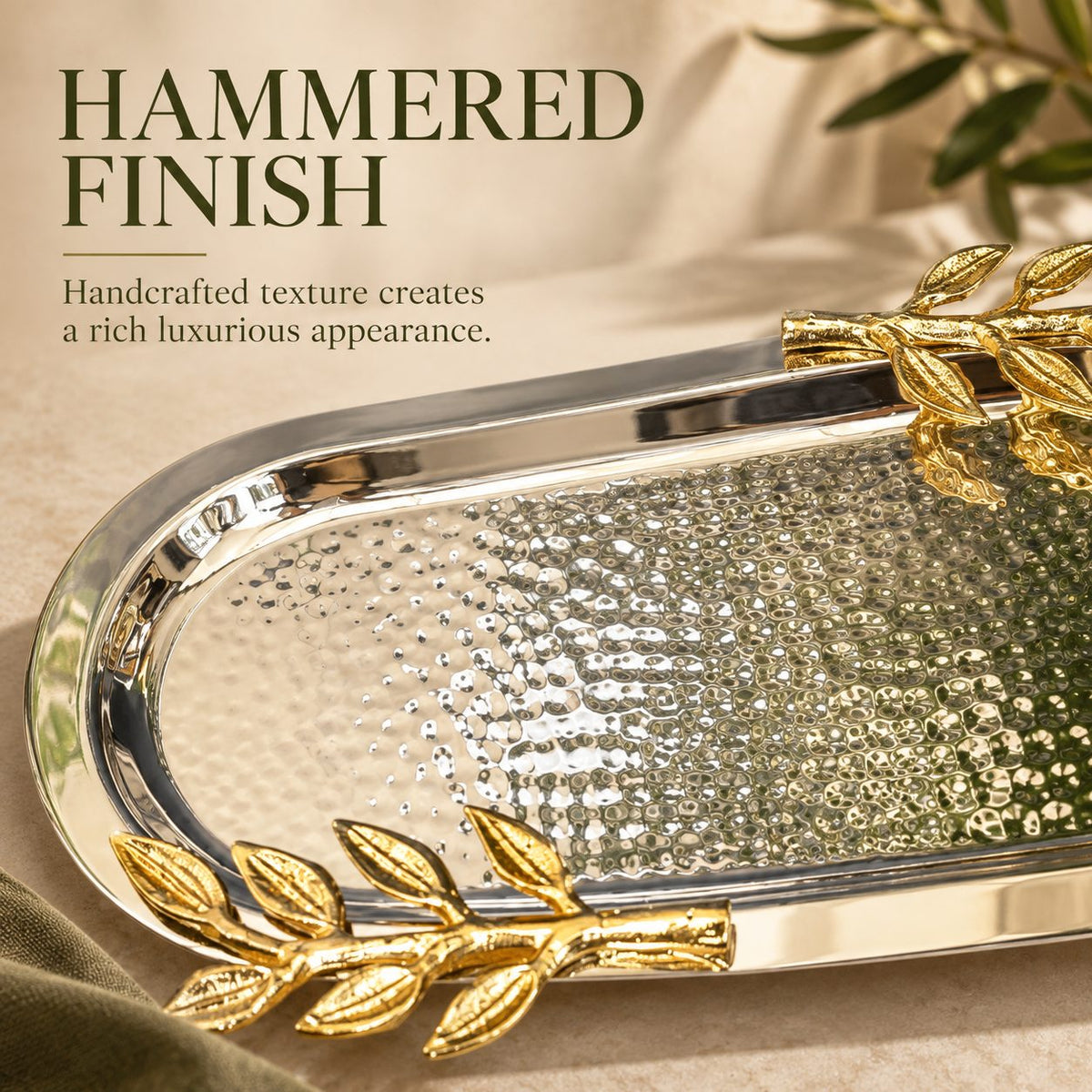 Close-up of the handcrafted hammered stainless steel surface and gold leaf handles of the luxury Leaf Handle Serving Tray.