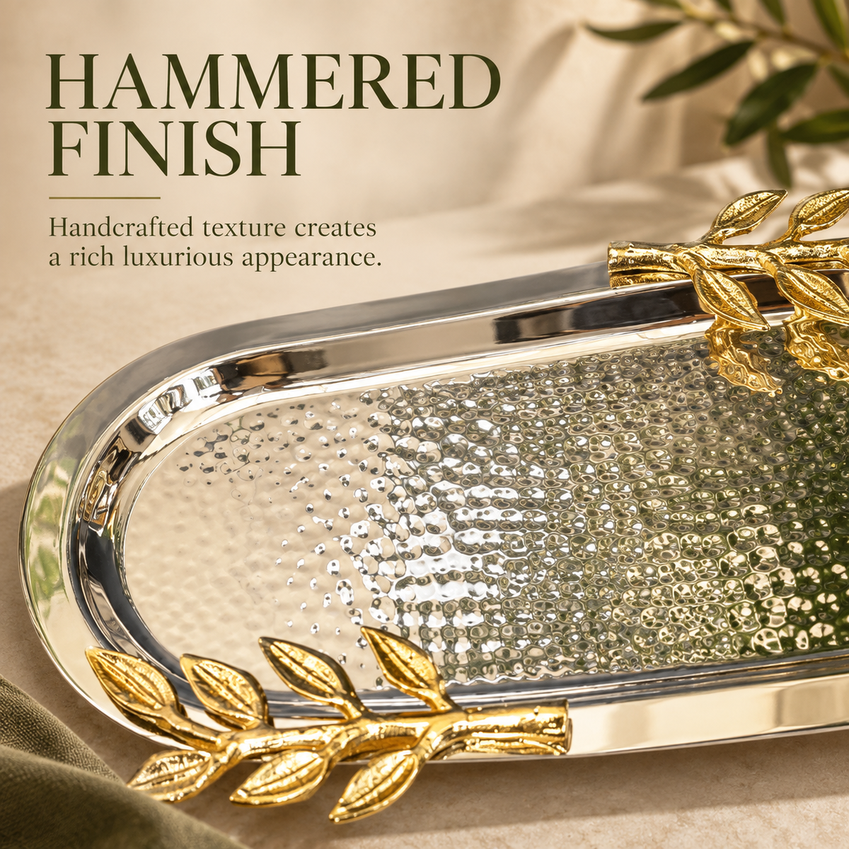 Close-up of the handcrafted hammered stainless steel surface and gold leaf handles of the luxury Leaf Handle Serving Tray.