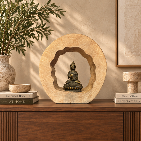 Handcrafted wooden Buddha meditation sculpture displayed on a walnut console in a luxury contemporary living room with warm neutral décor.