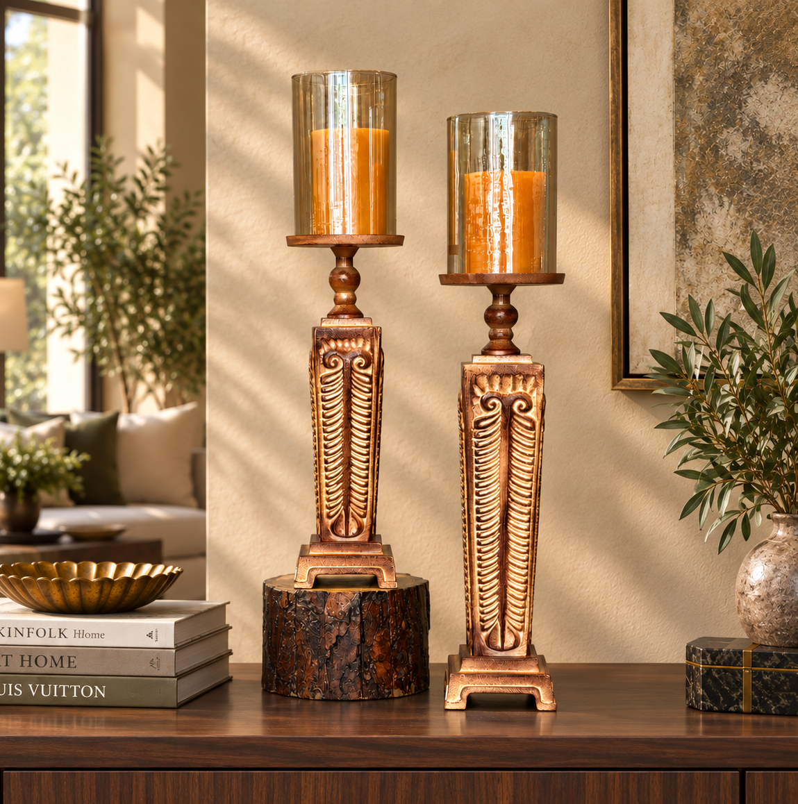 Decorative carved wooden hurricane candle holder set styled on a luxury walnut console table in a contemporary living room with warm natural light.