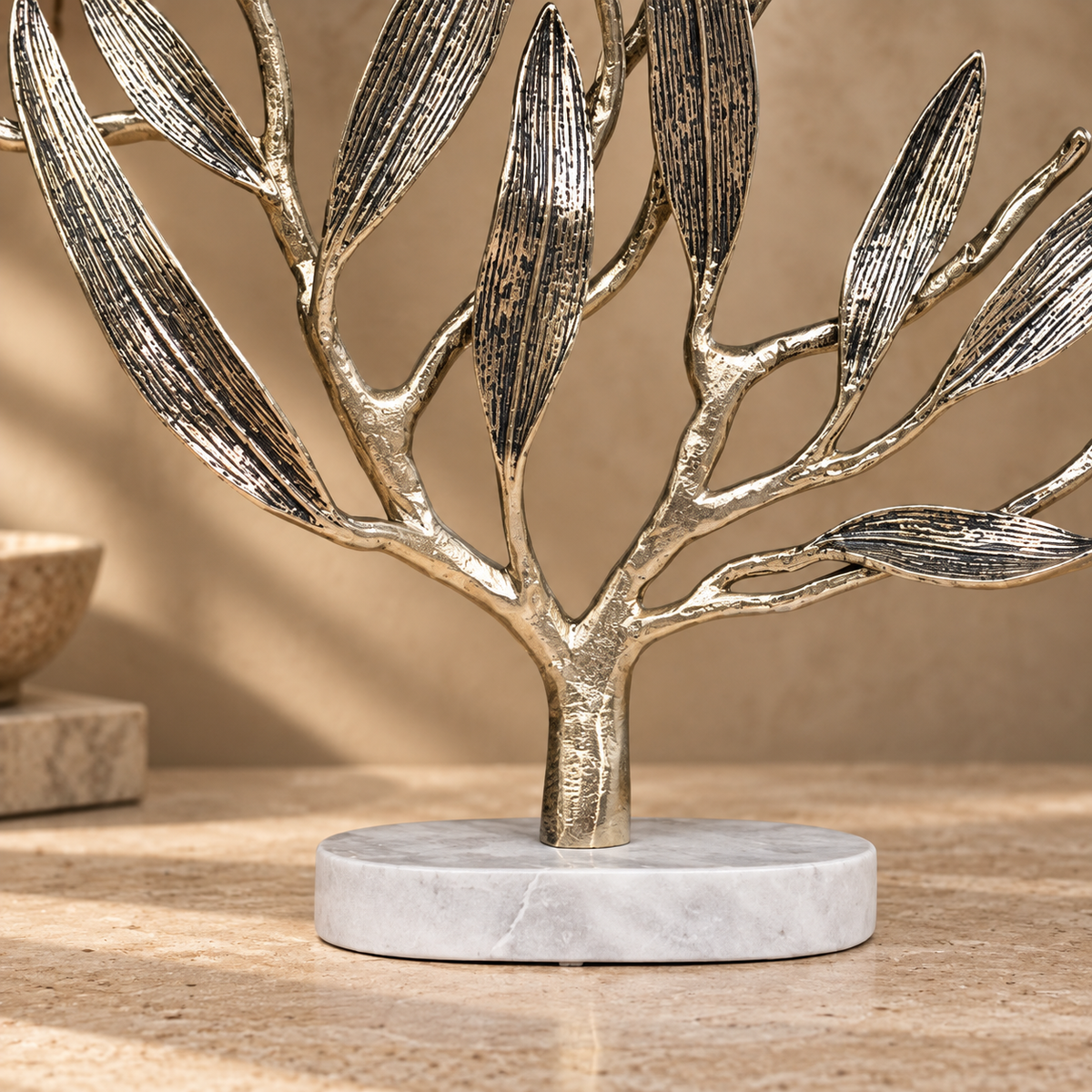 Premium metal olive tree sculpture featuring a solid white marble base with elegant handcrafted branches and textured leaves.