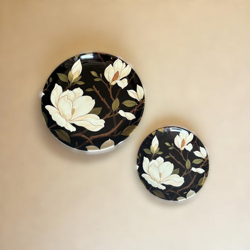 Midnight Mangolia Ceramic Wall Plate – This beautiful wall plate shows soft cream magnolia flowers blooming gently against a rich black | INARA