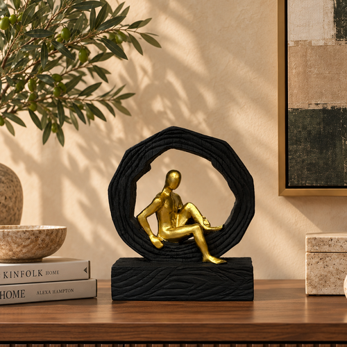 Modern abstract gold and black resin sculpture displayed on a walnut console table in a luxury living room with contemporary décor.
