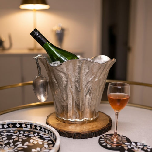 Premium handcrafted aluminium ice bucket with matching scoop on a luxury studio background showcasing its sculptural organic design.