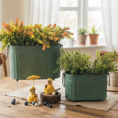 Vintage patina ribbed metal planter set with artificial greenery displayed on a wooden table in a bright luxury home interior.