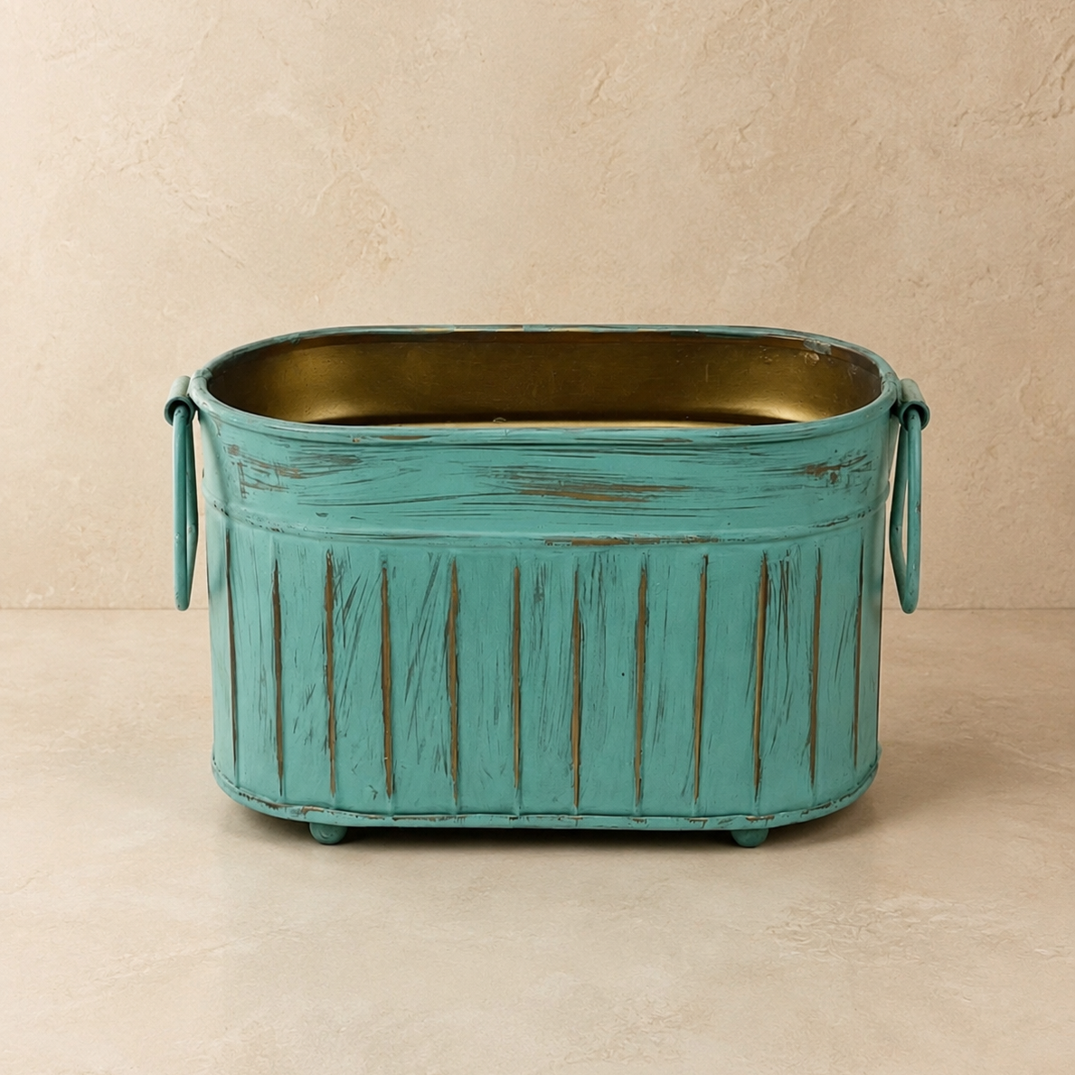 Front view of the handcrafted Vintage Patina Ribbed Metal Planter with distressed turquoise finish, decorative side handles, and antique brass interior on a neutral background.