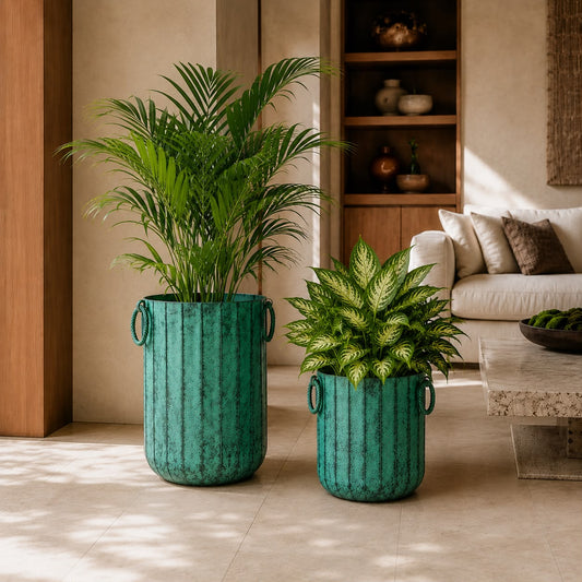 Luxury green metal planter set with tropical indoor plants styled in a modern living room with warm contemporary interiors.