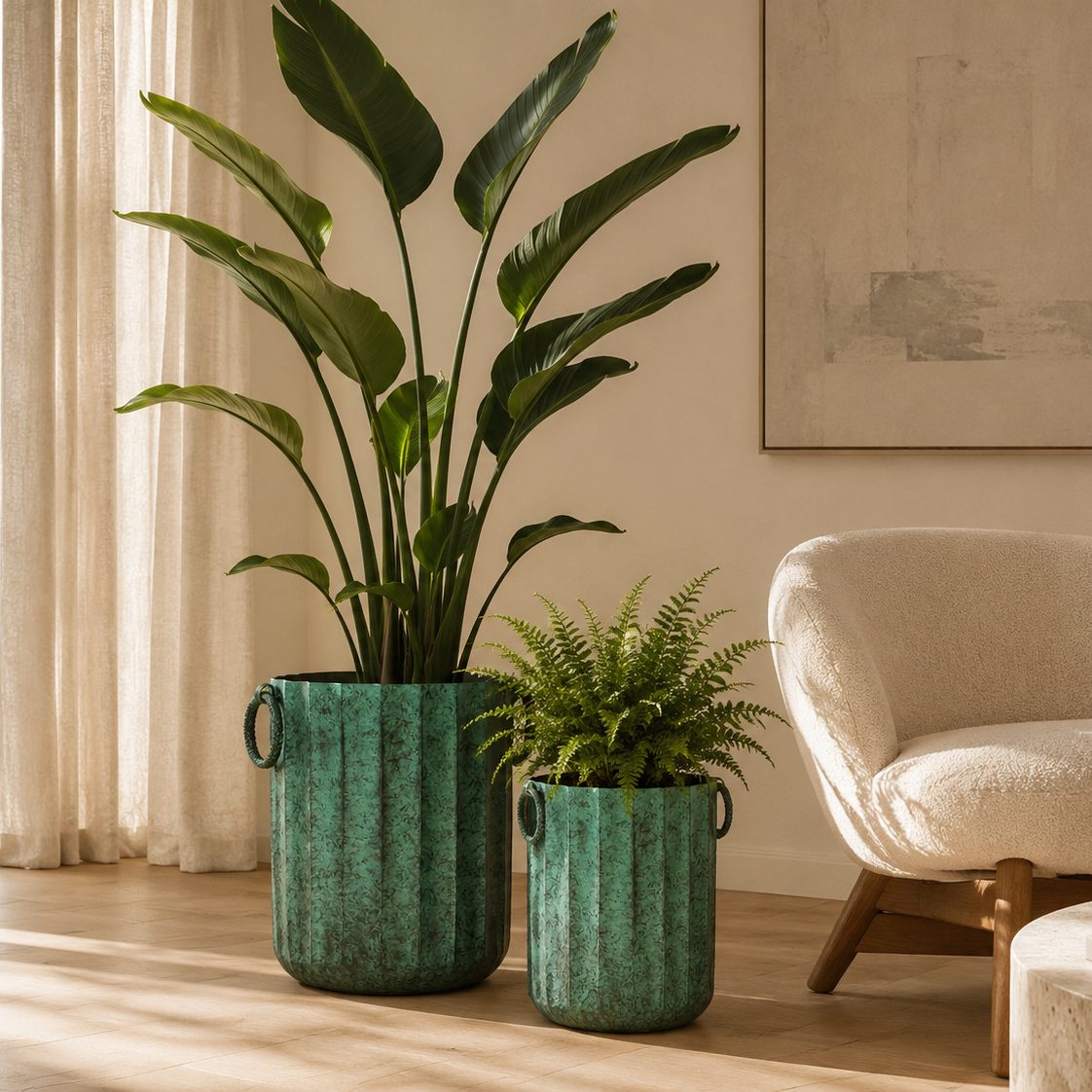 Large and small vintage green metal planters styled with indoor plants in a modern luxury living room with natural sunlight.