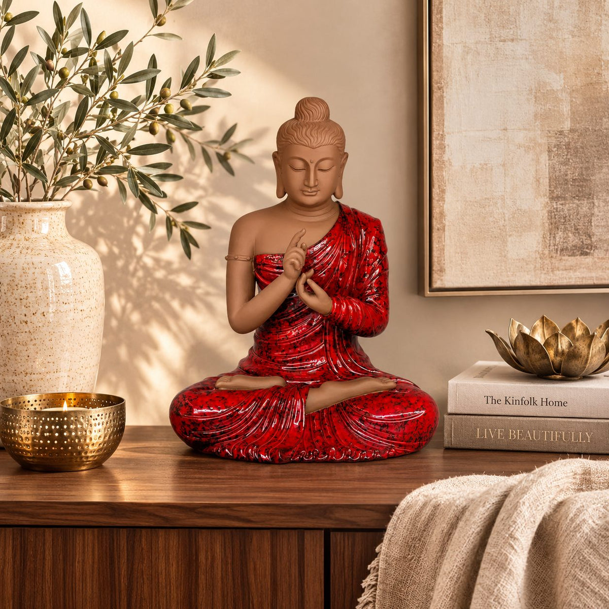 Premium handcrafted red Buddha statue displayed on a luxury wooden console with elegant home décor accessories, perfect for living rooms and meditation spaces.