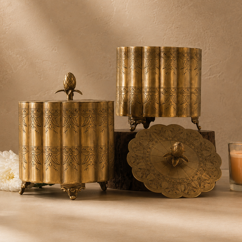 Premium antique brass decorative storage box with engraved detailing and pineapple finial, styled in a luxury studio setting with a warm beige Venetian plaster wall and seamless microcement floor, ideal for elegant home décor and tabletop styling.