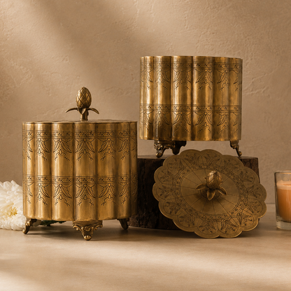 Premium antique brass decorative storage box with engraved detailing and pineapple finial, styled in a luxury studio setting with a warm beige Venetian plaster wall and seamless microcement floor, ideal for elegant home décor and tabletop styling.
