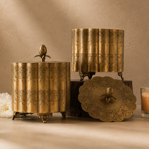 Premium antique brass decorative storage box with engraved detailing and pineapple finial, styled in a luxury studio setting with a warm beige Venetian plaster wall and seamless microcement floor, ideal for elegant home décor and tabletop styling.