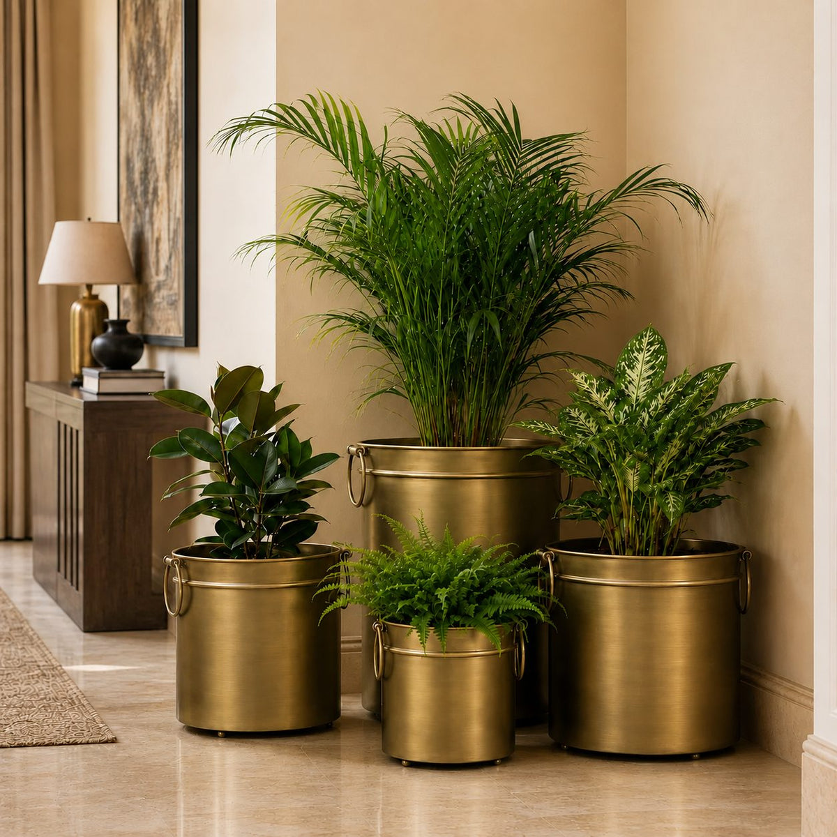 Premium brass indoor planter set styled with lush indoor plants in a modern luxury living room.