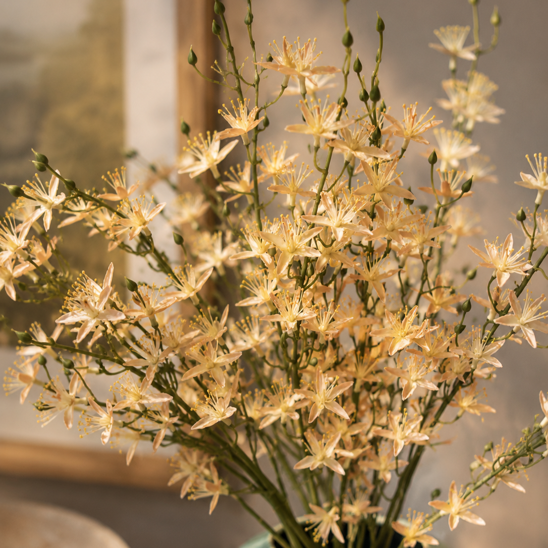 Close-up of premium artificial white wildflower stems featuring realistic petals, delicate buds, and natural green stems for elegant floral arrangements.