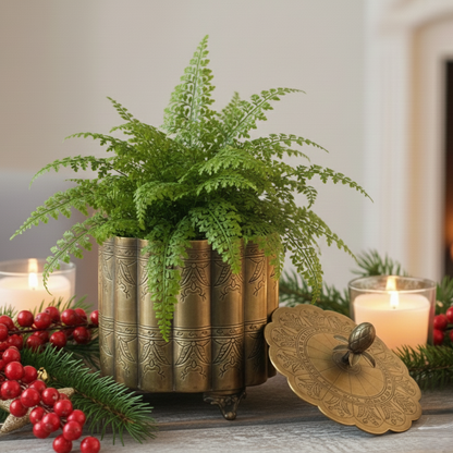 Antique gold brass planter box with engraved detailing, styled with a green fern plant, festive candles, and decorative berries for luxury home décor