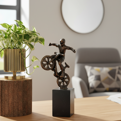 High-end interior photography featuring a dynamic metal biker sculpture performing a wheelie, displayed as a centerpiece on a designer coffee table.