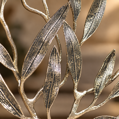 Close-up of premium textured metal olive tree sculpture showcasing intricate handcrafted leaf detailing and antique gold finish.