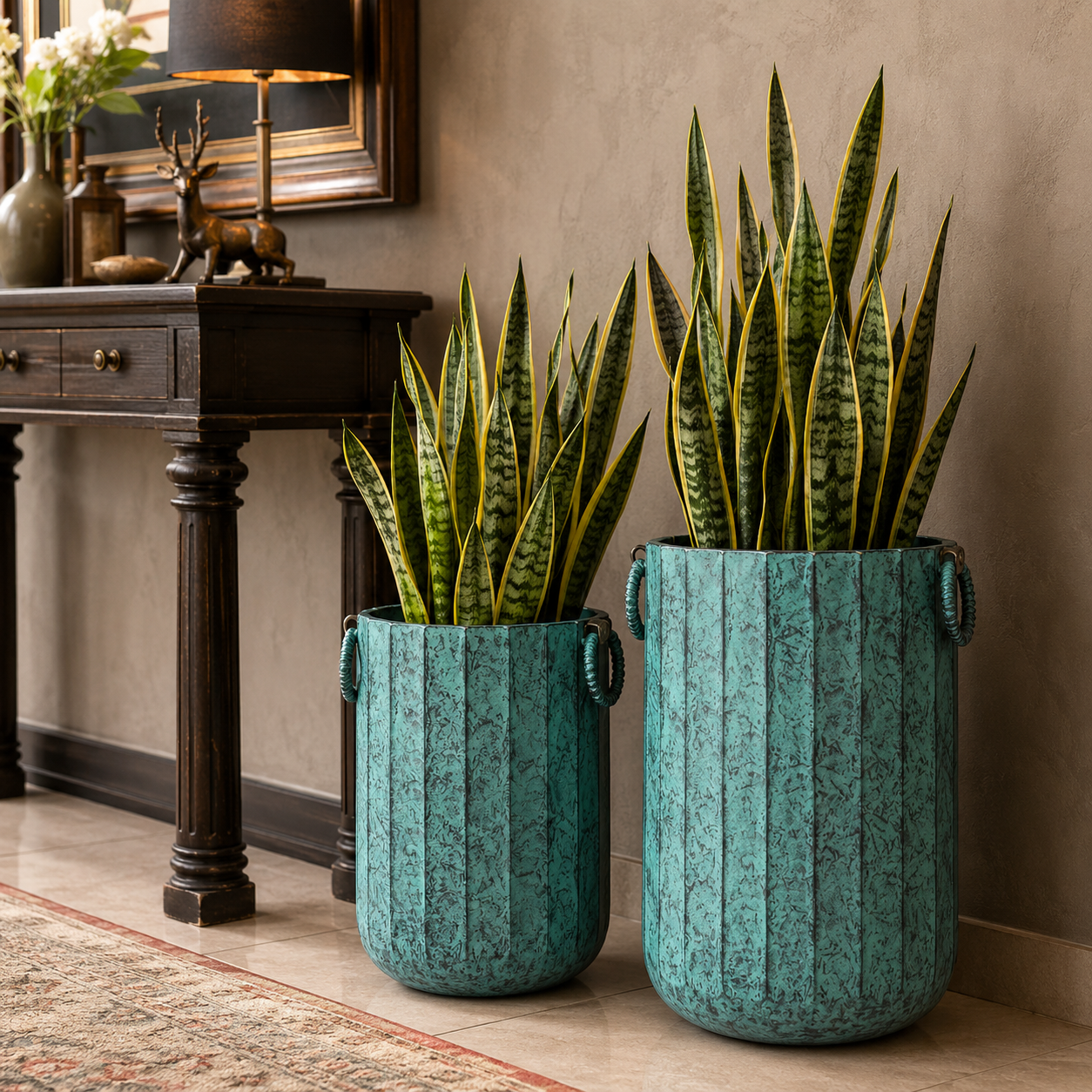 Premium patina green metal planter set with lush green and yellow snake plants beside a wooden console table.