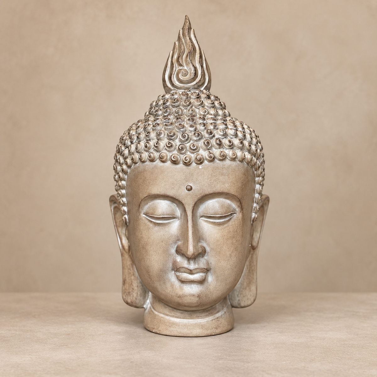 Front view of a premium resin Buddha head sculpture in an elegant champagne finish on a warm beige luxury background.