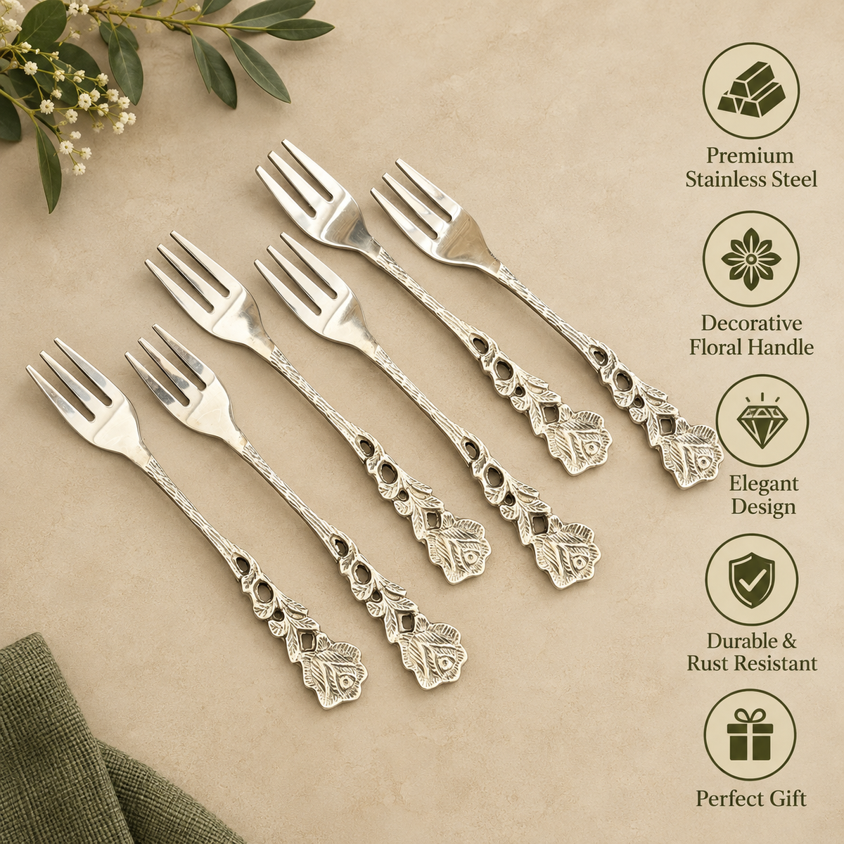 Premium stainless steel dessert forks set of 6 with elegant floral engraved handles displayed on a warm beige Venetian seamless matte microcement surface, featuring durable rust-resistant construction and decorative vintage design, ideal for serving desserts, cakes, fruits, and appetizers.