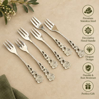 Premium stainless steel dessert forks set of 6 with elegant floral engraved handles displayed on a warm beige Venetian seamless matte microcement surface, featuring durable rust-resistant construction and decorative vintage design, ideal for serving desserts, cakes, fruits, and appetizers.