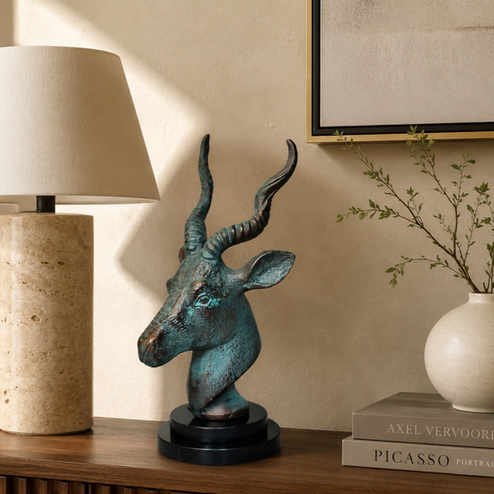 Luxury handcrafted antique bronze deer head sculpture with a textured verdigris finish on a polished black marble base, showcased from multiple angles to highlight its intricate detailing, premium craftsmanship, and elegant design for sophisticated home and office décor.