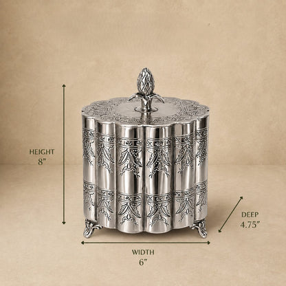 Silver decorative metal storage box with engraved floral pattern and lid, dimensions 6 inches wide, 4.75 inches deep, and 8 inches high, displayed on a beige background.