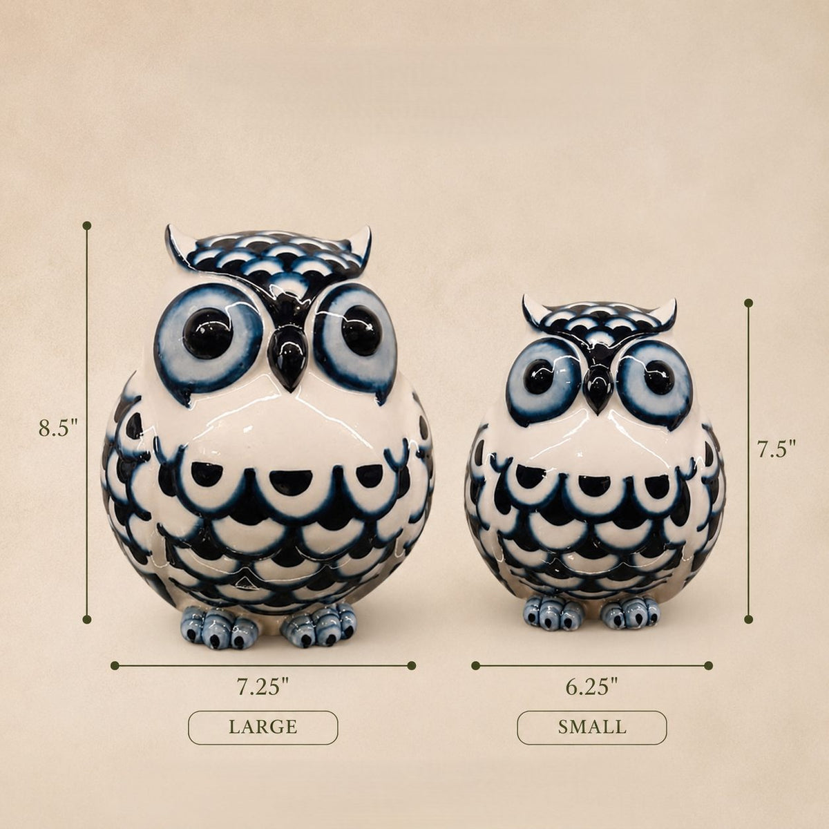 Dimensions guide for Inara Home Decor blue and white ceramic owl figurines showing the large owl measuring 8.5 inches high × 7.25 inches wide and the small owl measuring 7.5 inches high × 6.25 inches wide on a warm beige background.