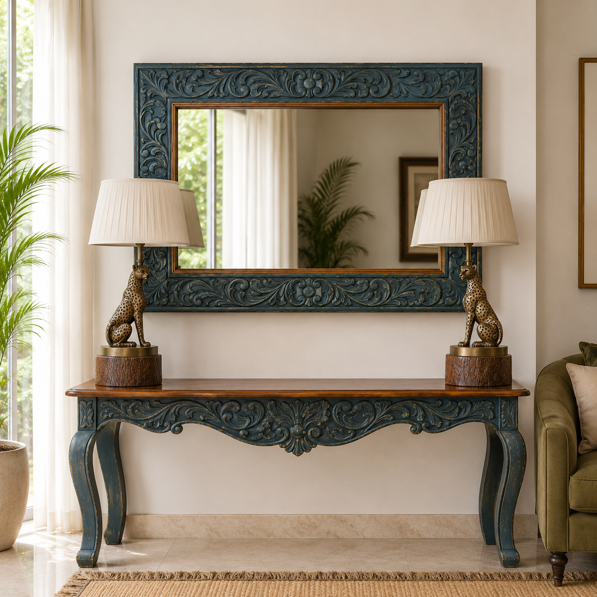 Handcrafted carved wood console table with a matching slightly rectangular carved wall mirror, styled in a luxury living room with two leopard table lamps facing each other and illuminated by natural daylight.