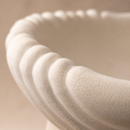 Close-up of the scalloped edge and sandstone-inspired matte texture of the white ceramic urli, highlighting premium craftsmanship.