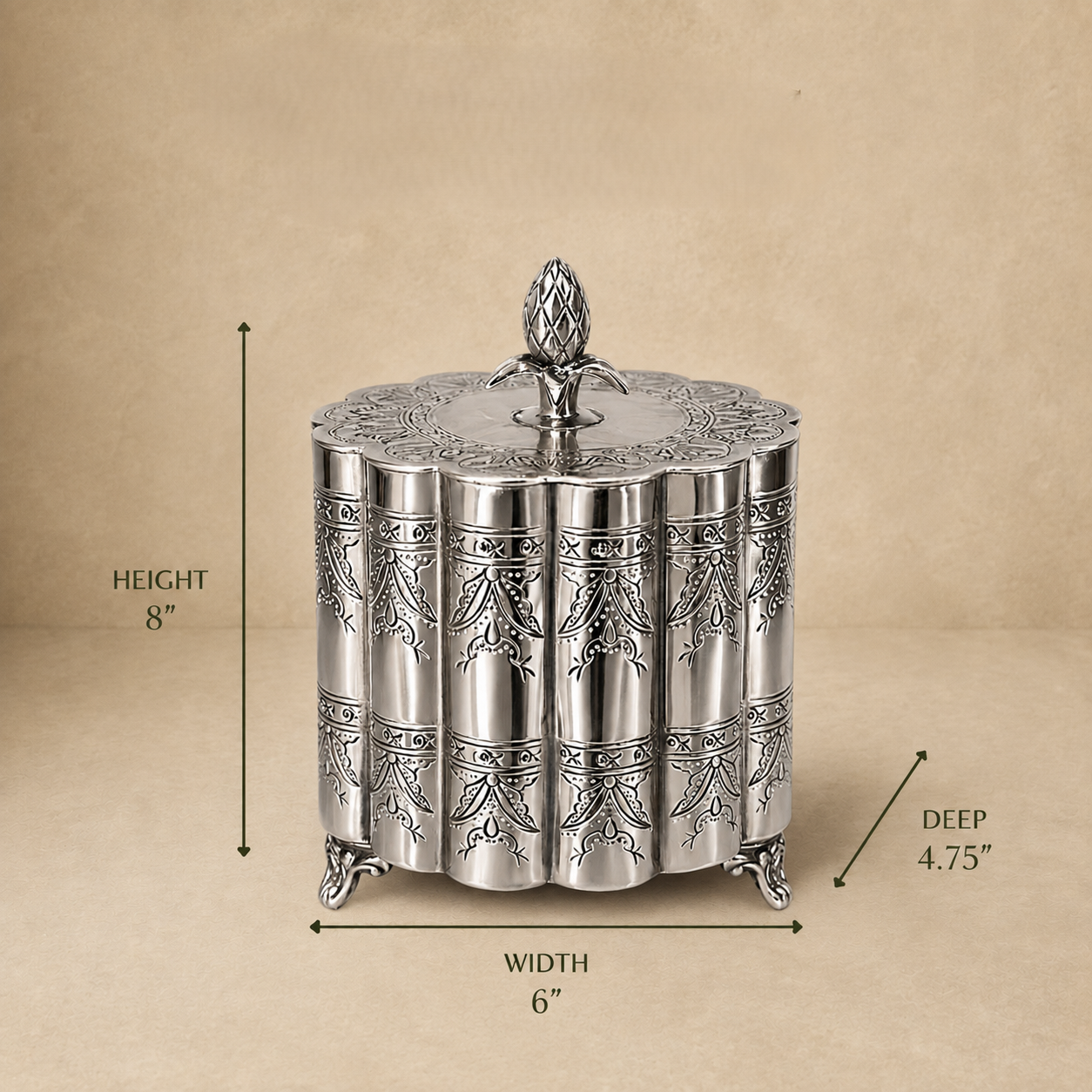 Silver decorative metal storage box with engraved floral pattern and lid, dimensions 6 inches wide, 4.75 inches deep, and 8 inches high, displayed on a beige background.
