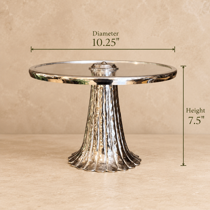 Dimensions of the silver pedestal serving stand with glass top measuring 10.25-inch diameter and 7.5-inch height.
