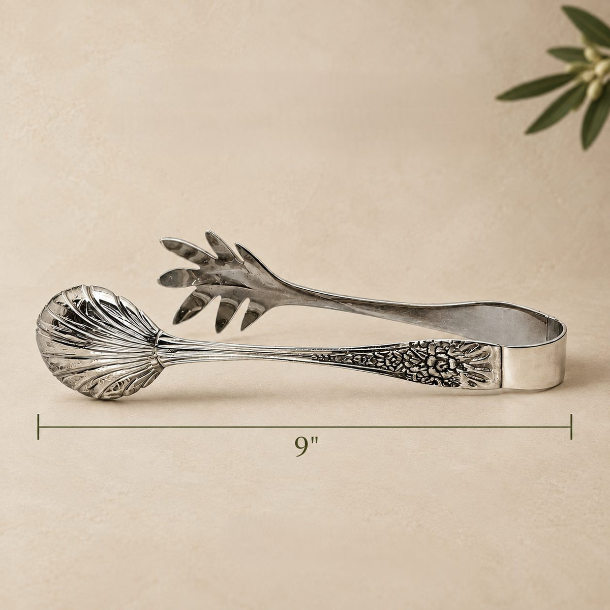 9-inch silver salad serving tongs with engraved handle and polished stainless steel finish, ideal for serving salads elegantly.