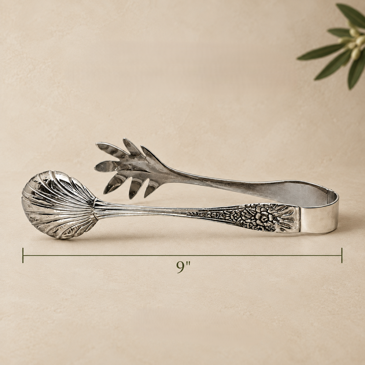 9-inch silver salad serving tongs with engraved handle and polished stainless steel finish, ideal for serving salads elegantly.