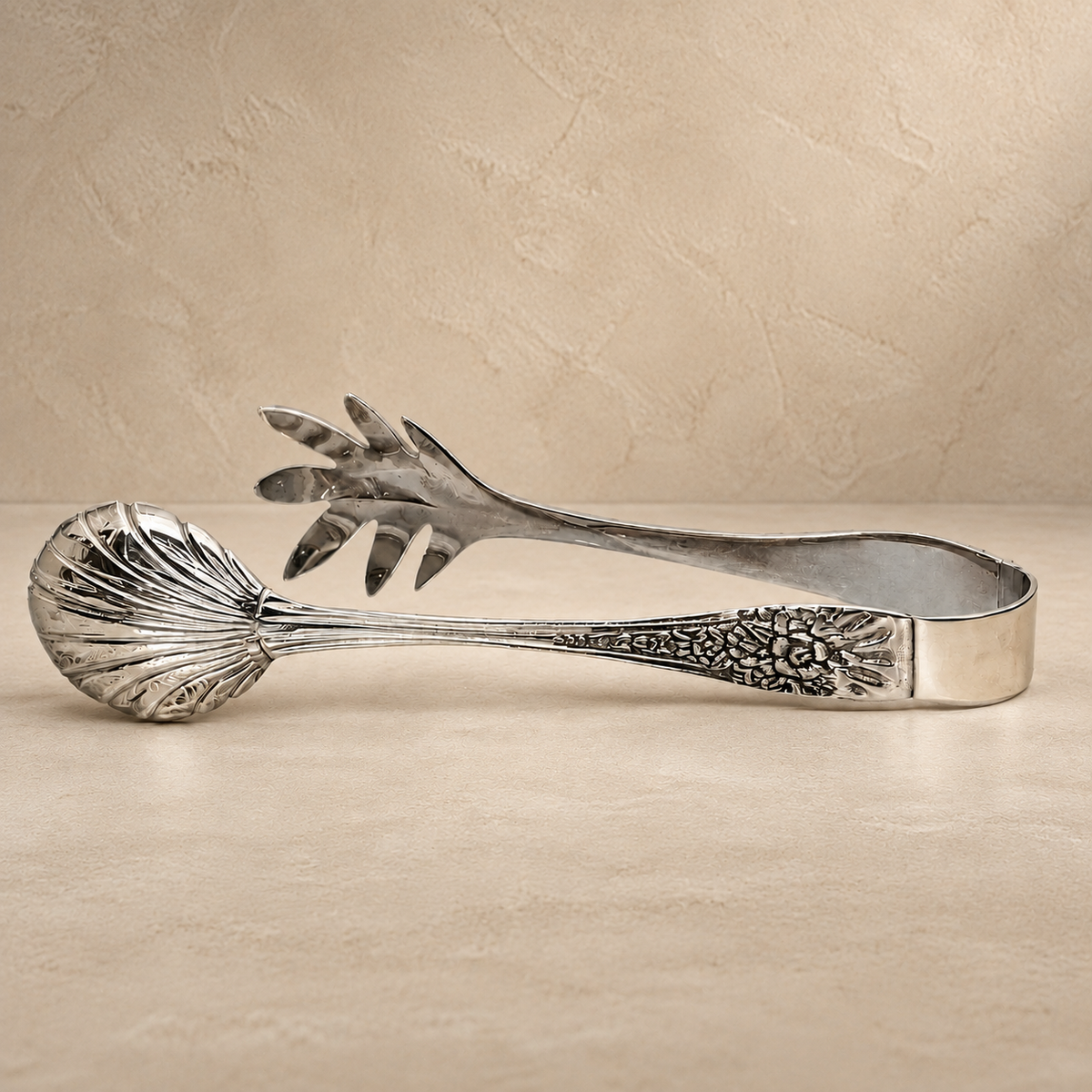 Premium handcrafted silver salad serving tongs with decorative engraved handles in a luxury studio setting by Inara Home Decor.