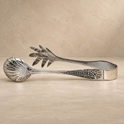 Premium handcrafted silver salad serving tongs with decorative engraved handles in a luxury studio setting by Inara Home Decor.
