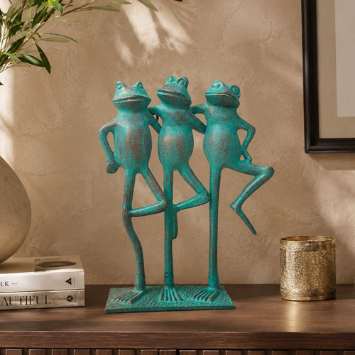 Handcrafted three frogs decorative sculpture styled on a premium wooden console against a textured beige wall with elegant décor accents in soft natural daylight, adding a playful yet sophisticated touch to a luxury living space.
