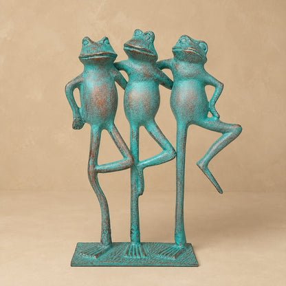 Three frogs decorative sculpture with a handcrafted turquoise patina finish, standing together on a sturdy base against a warm beige backdrop. A whimsical luxury home décor accent for console tables, shelves, and living room styling.