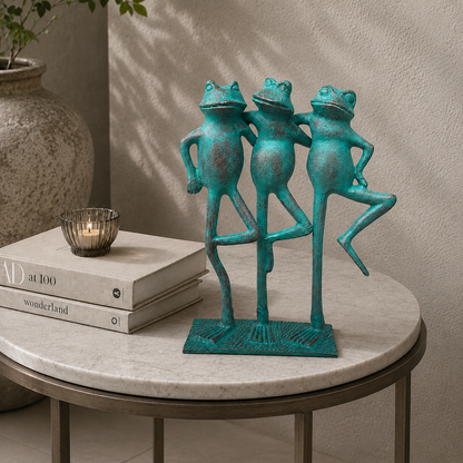 Handcrafted turquoise metal frog trio sculpture styled on a luxury marble side table with books and candle in a modern living room interior.