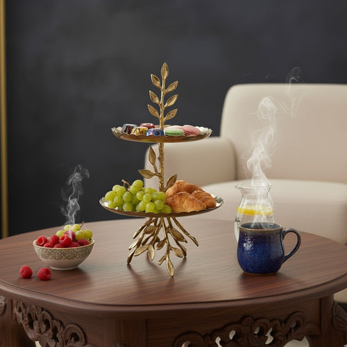 Two-tier stainless steel serving stand with decorative brass leaf accents.